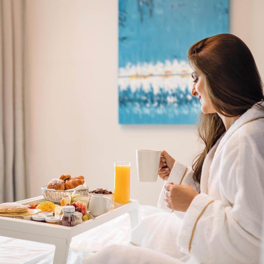 Centara West Bay Hotel & Residences Доха Екстериор снимка A woman in a bathrobe